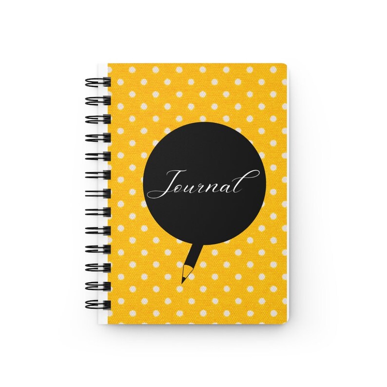 May include: Yellow journal with white polka dots and a black circle with the word "Journal" written in white. A black pencil is drawn coming out of the circle.