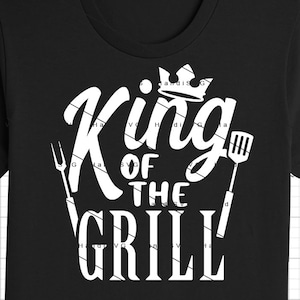 May include: Black t-shirt with white text that reads "King of the Grill" with a crown and grill tools.