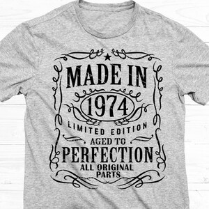 May include: A gray t-shirt with a black graphic design that says "Made in 1974 Limited Edition Aged to Perfection All Original Parts".