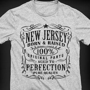 May include: A gray t-shirt with a black graphic design that says "New Jersey Born & Raised 100% Original Parts Aged to Perfection Pure Quality" in a vintage style font.