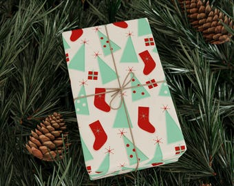 May include: Wrapped gift with a festive Christmas pattern. The wrapping paper features light green Christmas trees, red stockings, and gift boxes on a cream background. Tied with twine, the gift is surrounded by pine needles and pine cones.