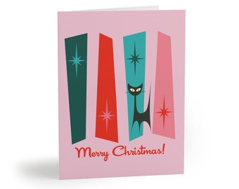 Könnte beinhalten: Eine rosafarbene Weihnachtskarte mit einer schwarzen Katze vor einem bunten abstrakten Design. Die Karte trägt den Text "Frohe Weihnachten!"
