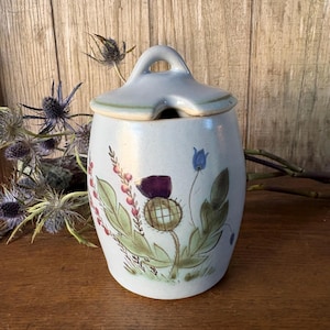 May include: A set of three ceramic mugs with a speckled, matte finish. The mugs are in shades of cream, light gray, and dark gray. Each mug has a simple, minimalist design, perfect for coffee or tea.