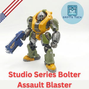 May include: A detailed action figure, featuring a yellow and olive green armored design with a blue blaster. The figure is labeled "Studio Series Bolter Assault Blaster" and includes a metallic silver head. The image also includes a small American flag.