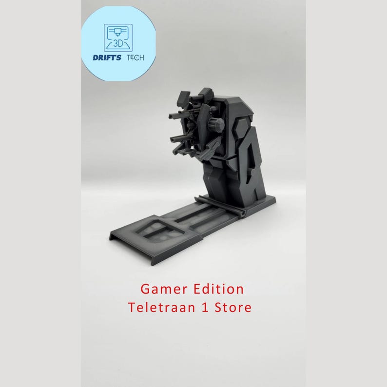 Puede incluir: Un modelo de una torreta con m&uacute;ltiples ca&ntilde;ones impreso en 3D en negro. La torreta est&aacute; montada en una base con una plataforma deslizante. El texto "Gamer Edition Teletraan 1 Store" est&aacute; impreso debajo del modelo.