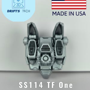 Op de afbeelding: Een zilveren SS114 TF One Jetpack Upgrade Kit. De kit is gemaakt in de VS en heeft een gedetailleerd, mechanisch ontwerp. De afbeelding bevat de tekst "Drifts Tech" en een 3D-logo.