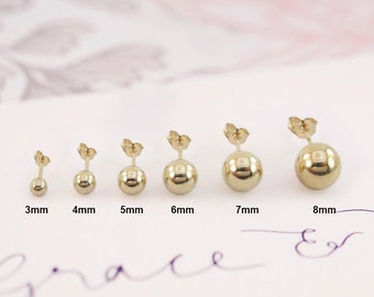 May include: Six gold ball stud earrings in different sizes, ranging from 3mm to 8mm. The earrings are displayed on a white surface with the size of each earring labeled below.