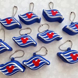 May include: A collection of ten blue and white striped cruise ship funnel-shaped keychains, each featuring a red Mickey Mouse head silhouette and a silver-toned metal ball chain attached to the top for hanging or securing to items.
