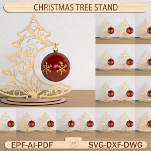May include: A wooden Christmas tree stand with a cutout tree design, holding a red ornament with gold snowflake details. The image includes the text "CHRISTMAS TREE STAND" and file type options.
