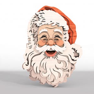 May include: A multi-layered wooden wall decoration featuring a smiling Santa Claus face. The design uses stacked light-colored wood for the beard, mustache, and hair, with a red wooden hat and pinkish-toned cheeks, creating a dimensional effect.