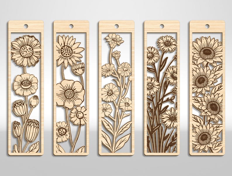 May include: Five wooden bookmarks with floral designs. Each bookmark features a different laser-cut flower arrangement, including sunflowers and other blooms, set within a rectangular frame. The bookmarks have a small hole at the top for a tassel or string.