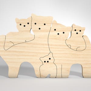 May include: A wooden cutout of a family of cats, with four cats of different sizes standing next to each other. The cats are all facing forward and have simple, black line features for eyes and noses.