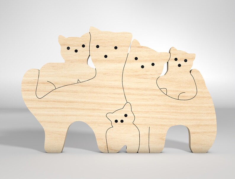 May include: A wooden cutout of a family of cats, with four cats of different sizes standing next to each other. The cats are all facing forward and have simple, black line features for eyes and noses.
