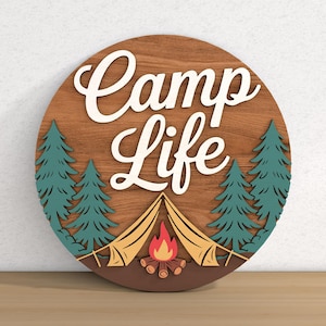 May include: A round wooden sign with the words "Camp Life" in white script. The sign features a camping scene with a tent, campfire, and pine trees in shades of green, brown, and yellow.