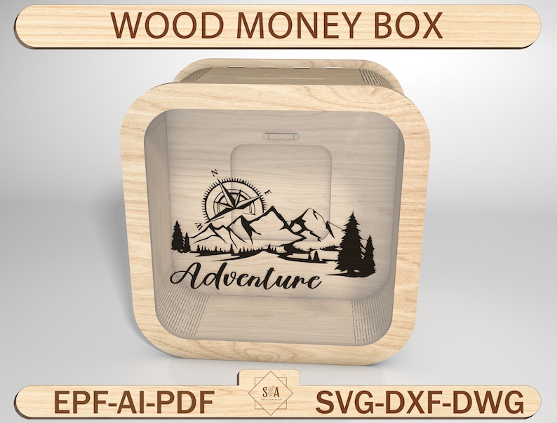 May include: A wooden money box with a clear front panel. The box has a compass, mountains, and trees engraved on the front. The text "Adventure" is also engraved on the front of the box.