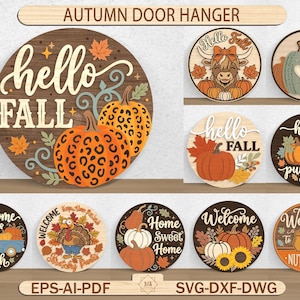 Puede incluir: Una colección de diez colgadores de puerta circulares de madera con temas otoñales. Los diseños incluyen calabazas con estampado de leopardo, una vaca highland, un camión azul, un pavo y girasoles. Los textos incluyen "hello FALL" y "Welcome".