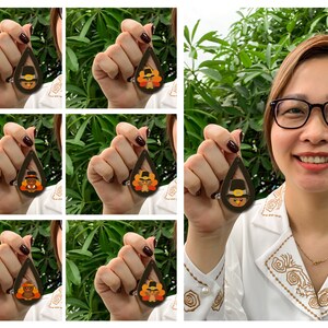 May include: A set of six pairs of dangle earrings featuring a brown teardrop-shaped design with a cartoon turkey wearing a pilgrim hat. The turkey is depicted in various colors, including orange, yellow, and brown.