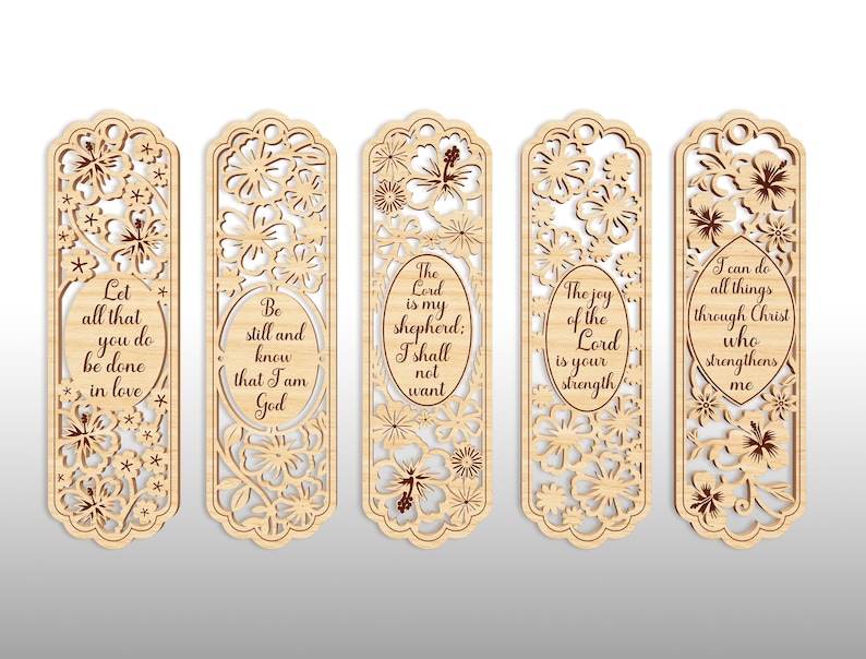 May include: Set of five wooden bookmarks with floral cutouts and inspirational quotes. Each bookmark features a unique design with phrases like "Let all that you do be done in love" and "The Lord is my shepherd."