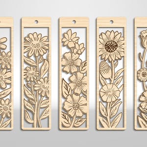 May include: Five wooden bookmarks with floral designs. Each bookmark features a different flower pattern, including daisies, sunflowers, and other blooms. The bookmarks are rectangular with a cutout design and a small hole at the top for a string.