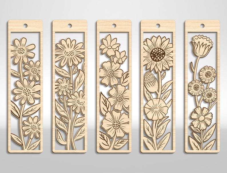 May include: Five wooden bookmarks with floral designs. Each bookmark features a different flower pattern, including daisies, sunflowers, and other blooms. The bookmarks are rectangular with a cutout design and a small hole at the top for a string.