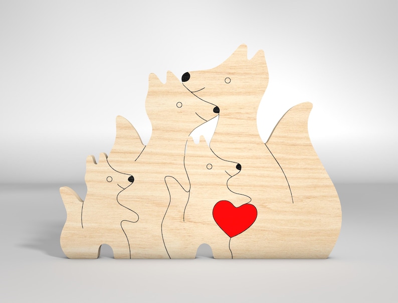 May include: Wooden cutout of a family of foxes, with a red heart in the center. The foxes are all facing forward, with the largest fox in the back and the smallest fox in the front. The foxes are all in a hugging position, with their tails intertwined.