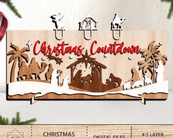 May include: Wooden Christmas countdown calendar with laser-cut nativity scene and decorative toppers. The words "Christmas Countdown" are in red. The calendar has numbers 1-24 for counting down the days until Christmas.