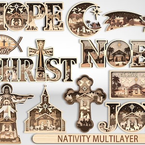 Op de afbeelding: Een verzameling meerlaagse, lasergesneden houten decoraties met religieuze thema's, waaronder de woorden HOPE, CHRIST, NOEL en JOY, een halve maan, een ster, een kruis, een vissymbool met het woord Faith en een Oh Holy Night bord.