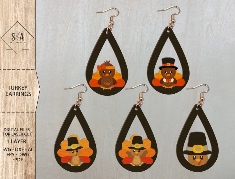 May include: Four pairs of laser cut wooden earrings featuring a Thanksgiving turkey design. Each earring is shaped like a teardrop and features a turkey with a pilgrim hat and a brown, orange, and yellow feather design.