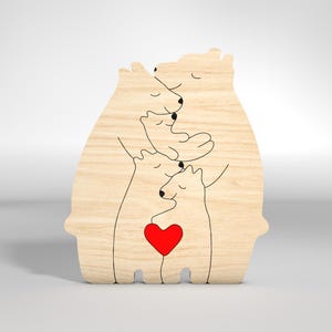 May include: Wooden cutout of a family of four polar bears hugging each other. The bears are outlined in black and the bottom bear has a red heart in its chest.