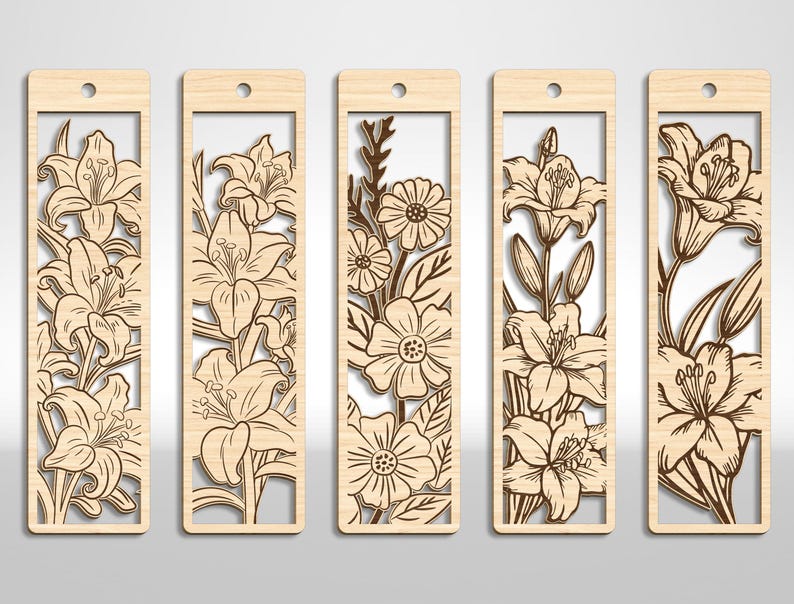 May include: Set of five wooden bookmarks with laser-cut floral designs. Each bookmark features a different flower arrangement, including lilies and daisies, within a rectangular frame. The bookmarks have a natural wood finish and a small hole at the top for a tassel.