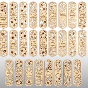May include: A collection of laser-cut wooden bookmarks with floral designs and inspirational quotes. Each bookmark features intricate cut-out patterns and text in a variety of fonts. The bookmarks are light brown with darker brown accents.