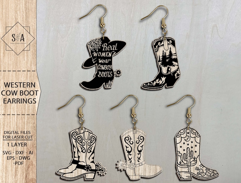 May include: Four pairs of laser cut wooden earrings shaped like cowboy boots. The boots have different designs, including a boot with a cactus, a boot with a mountain scene, and a boot with the text "Real Women Wear Cowboy Boots".