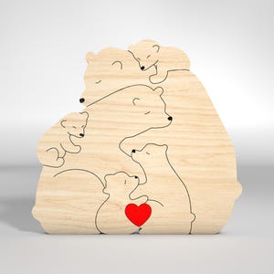 May include: A wooden cutout of a family of polar bears, with a mother bear holding a heart in her paw, surrounded by her cubs. The cutout is made of light brown wood and has a simple, minimalist design.