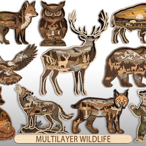 May include: A collection of multilayered wooden animal silhouettes including a fox, owl, bison, eagle, deer, bear, wolf, and lynx. Each cutout features intricate landscape scenes with mountains, forests, and rivers. The text MULTILAYER WILDLIFE is visible.