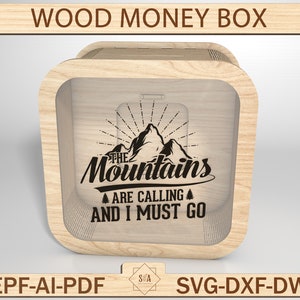 May include: A wooden money box with a clear front panel. The box has a design of mountains with the text "The Mountains Are Calling And I Must Go".