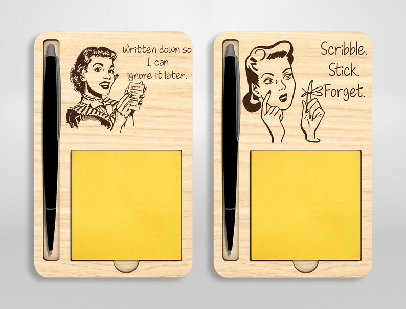 May include: A wooden desk organizer with a pen holder and a sticky note pad. The organizer features a retro-style illustration of a woman with the text "Written down so I can ignore it later." and "Scribble. Stick. Forget."