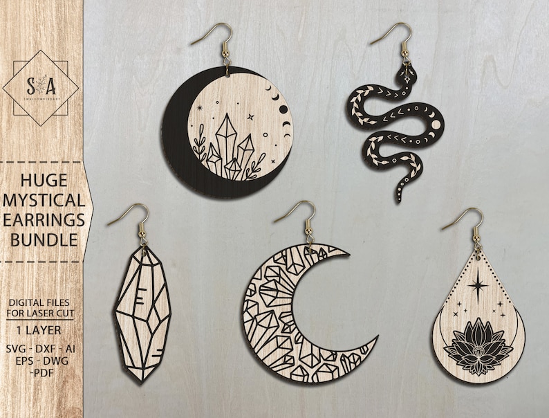 May include: Set of five laser cut wooden earrings featuring mystical designs. The earrings include a crescent moon with crystals, a snake with a crescent moon, a crystal, a crescent moon with crystals, and a teardrop with a lotus flower and a star.