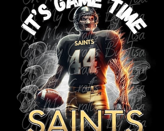 May include: Digital artwork featuring a football player in a Saints uniform with the text "IT'S GAME TIME" and "SAINTS". The player is depicted with a skeletal face and fiery arm, holding a football against a black background.