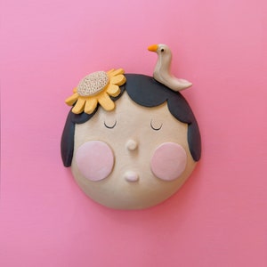 Handmade Glazed Ceramic Wall Art: Girl with Bird Wall Mask