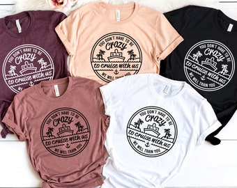 May include: Five t-shirts in different colors with a black and white graphic design that says "You don't have to be crazy to cruise with us, we will train you".