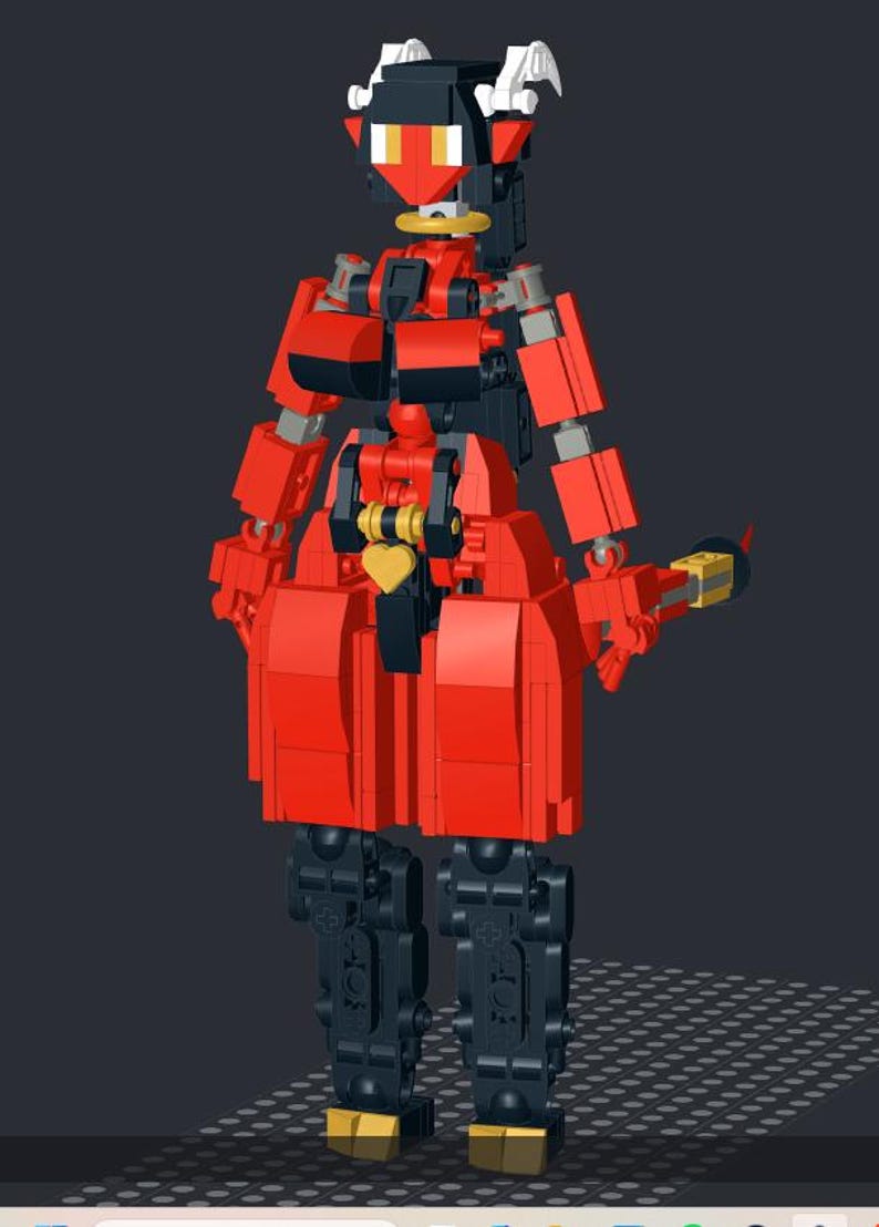 Op de afbeelding: Een rood en zwart Lego-figuur met een duivelachtig ontwerp. Het figuur heeft een rode torso, armen en benen, met zwarte accenten. Het heeft een hartvormig detail en een geel en goudkleurig wapen. Het figuur heeft een zwarte kop met witte hoorns.