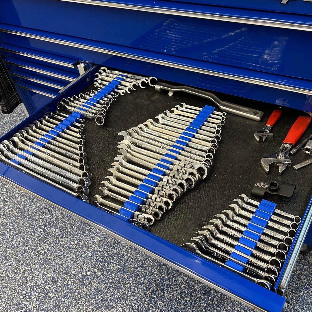 Hands of male car mechanic selecting wrench from tool box in repair garage  stock photo