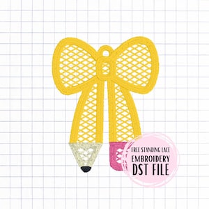 May include: A yellow pencil-shaped embroidery design with a bow at the top. The pencil has a white tip with a black point and a pink eraser. The design is on a grid background. Text in a pink circle reads "FREE STANDING LACE EMBROIDERY DST FILE".