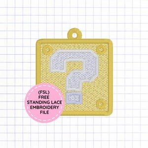 May include: A square yellow embroidered patch featuring a white question mark in the center and a small loop at the top. A pink circular overlay contains the text (FSL) FREE STANDING LACE EMBROIDERY FILE in black capital letters.