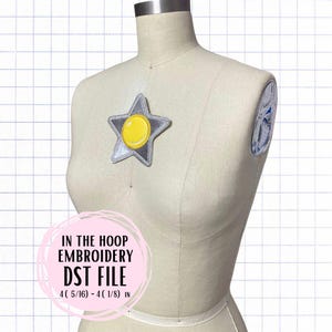 May include: A silver star with a yellow circle in the center. The star is on a white mannequin. The text "IN THE HOOP EMBROIDERY DST FILE 4 (5/16) - 4 (1/8) IN" is on a pink circle.