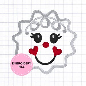 May include: An embroidery design featuring a stylized face with a scalloped gray outline, black oval eyes with white highlights, a small red circular nose, and a black curved mouth flanked by two red heart-shaped cheeks. A pink circle says EMBROIDERY FILE.