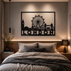 May include: A rectangular black metal wall art piece featuring a silhouette of the London skyline, including the Big Ben clock tower, the London Eye, and Tower Bridge. The word LONDON is cut out in large capital letters with ENGLAND below it.