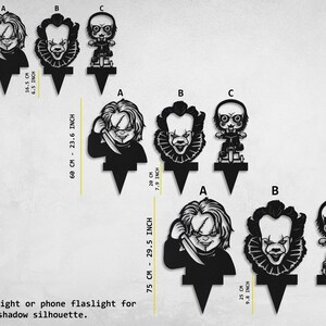 K&ouml;nnte beinhalten: Drei schwarze Silhouette-Kuchentopper mit Figuren aus Horrorfilmen. Die Topper sind 16,5 cm, 20 cm und 25 cm hoch. Verwenden Sie eine punktf&ouml;rmige Lichtquelle oder eine Taschenlampe, um eine Schatten-Silhouette zu erzeugen.