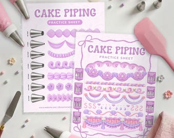 May include: Two cake piping practice sheets with purple text and illustrations of frosting patterns. The sheets feature diagrams of metal piping tips, various decorative borders, and swags. Included are pink piping bags, metal tips, and a spatula.