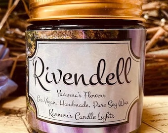 May include: A glass candle jar with a gold-colored metal lid and a label featuring the text Rivendell, Yavanna's Flowers, Eco. Vegan. Handmade. Pure Soy Wax, and Karmen's Candle Lights. The label has a purple and white floral design.